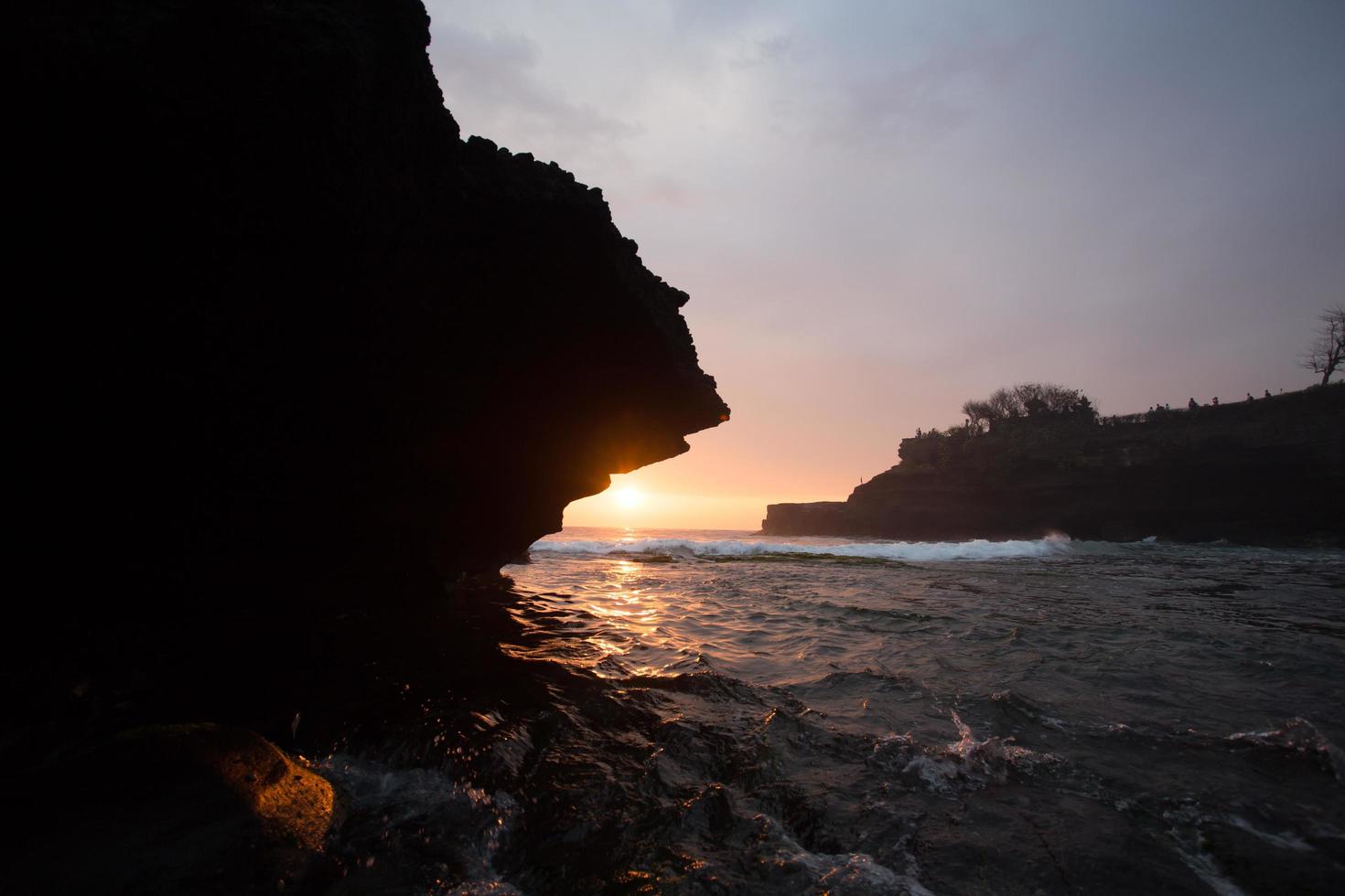 sunset over hindu temple Pura Tanah Lot, Bali, Indonesia photo