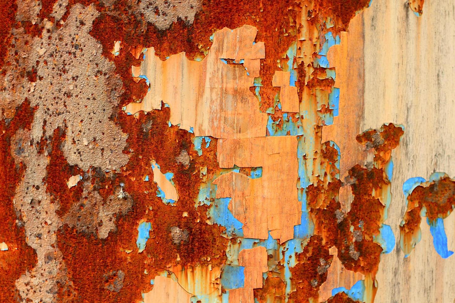 A rotted metal panel covered in rust photo