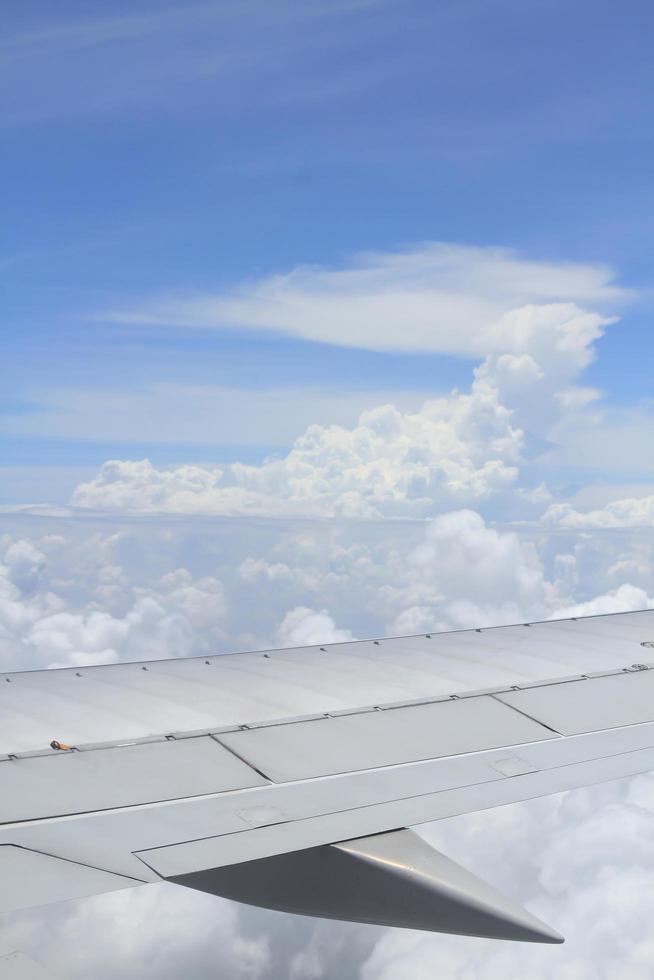 wing of the airplane under the clouds photo