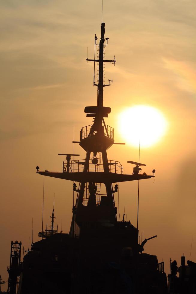 battleship with sunset behind photo