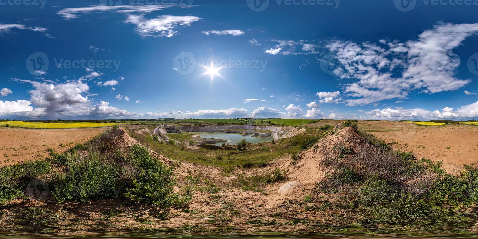 full seamless hdri panorama 360 degrees angle view near quarry flooded with water for sand extraction mining in sunny day with clear sky in equirectangular spherical projection for VR AR content photo