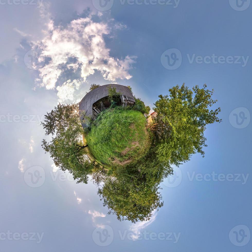 Little planet transformation of spherical panorama 360 degrees. Spherical abstract aerial view in field with awesome beautiful clouds. Curvature of space. photo