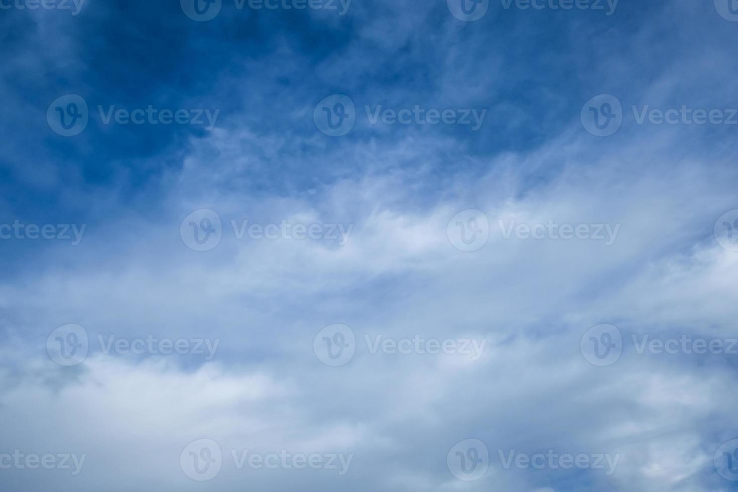Blue sky background with tiny stratus cirrus striped clouds. Clearing day and Good windy weather photo