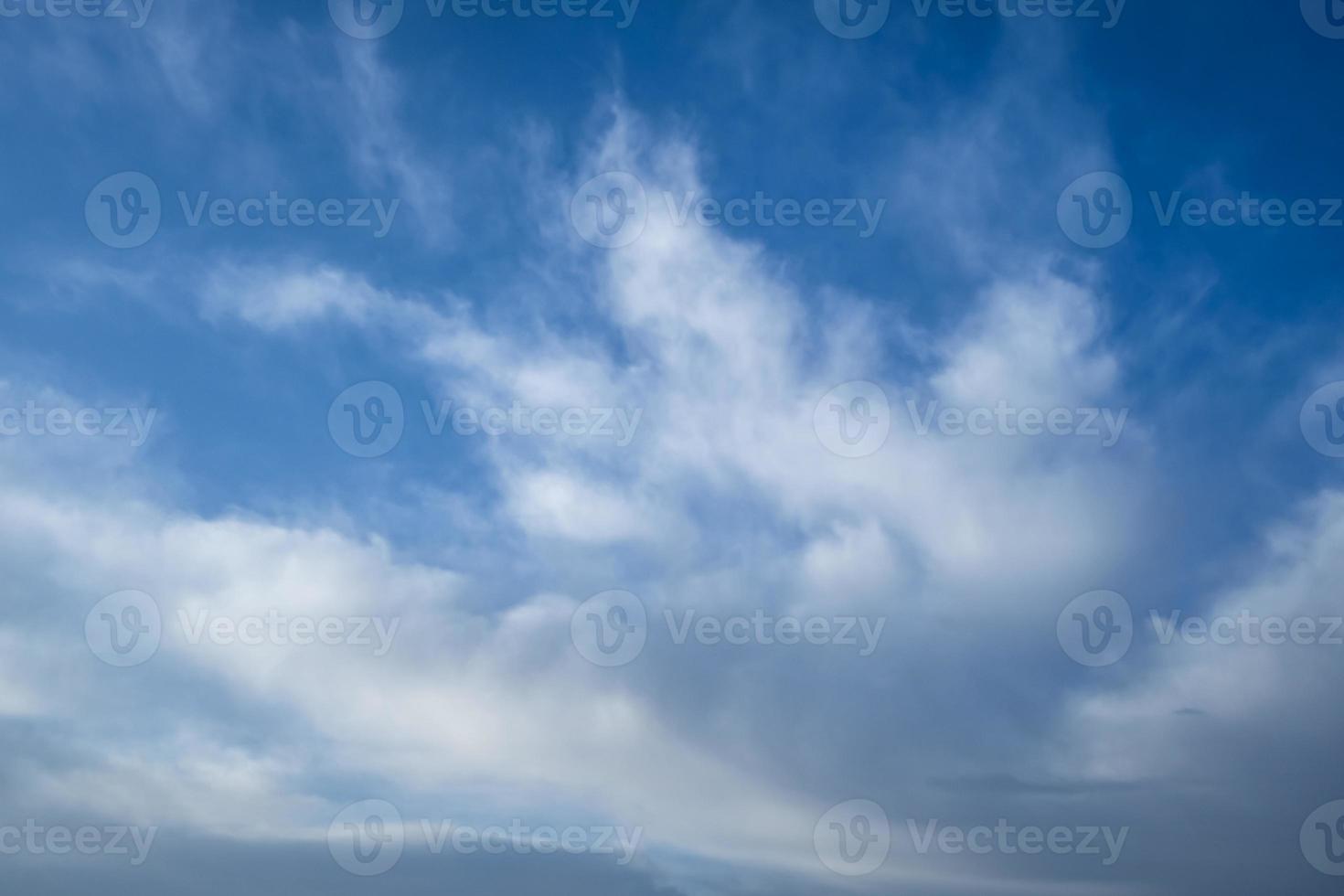 Blue sky background with tiny stratus cirrus striped clouds. Clearing day and Good windy weather photo