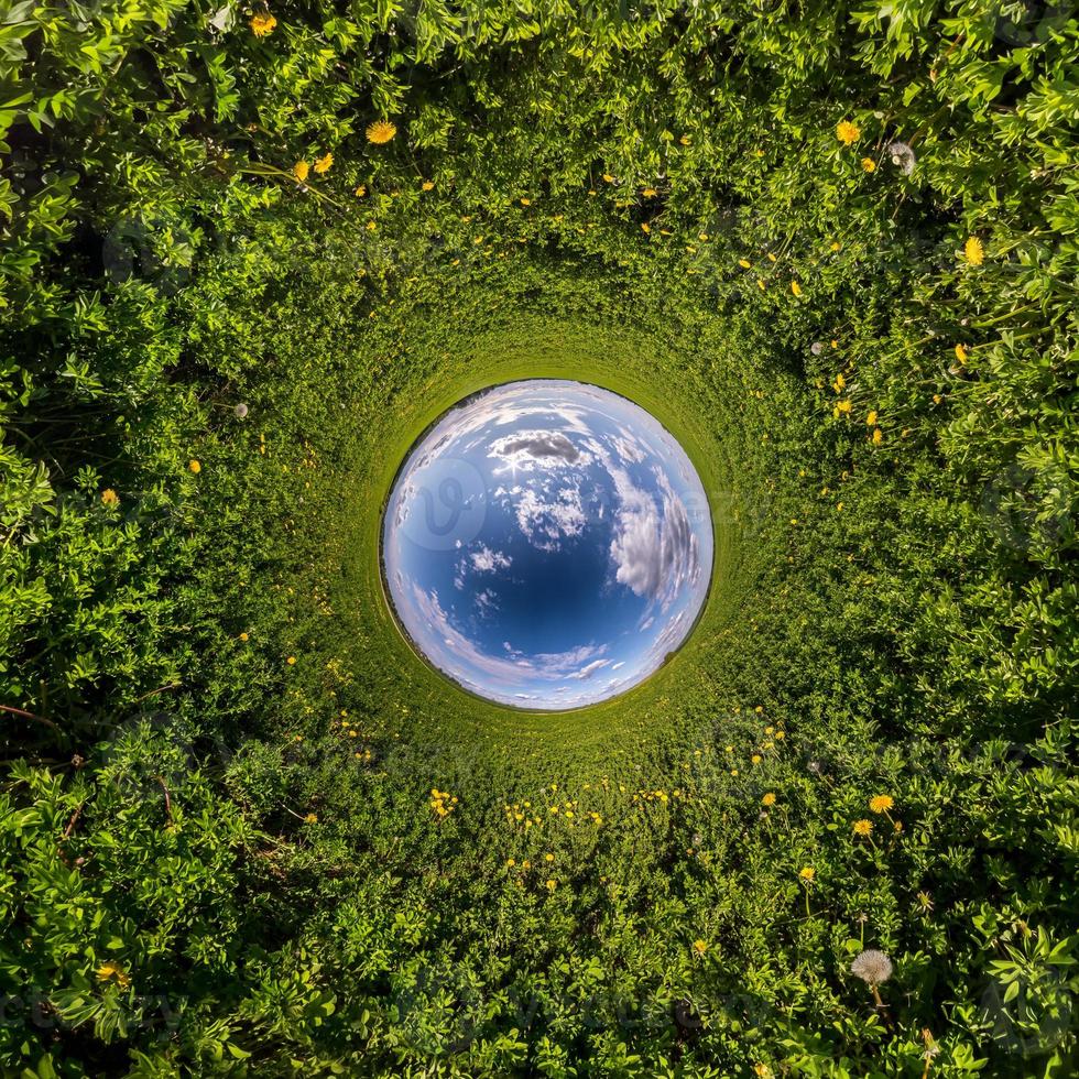 Inversion of little planet transformation of spherical panorama 360 degrees. Spherical abstract aerial view in field with awesome beautiful clouds. Curvature of space. photo