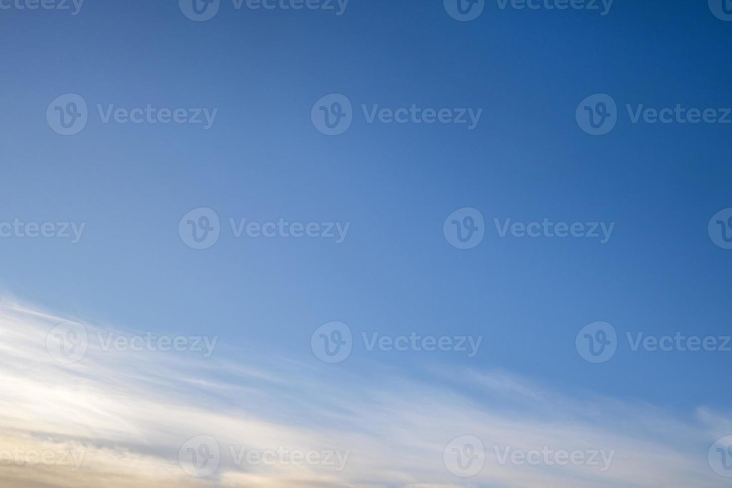Blue sky background with tiny stratus cirrus striped clouds. Clearing day and Good windy weather photo