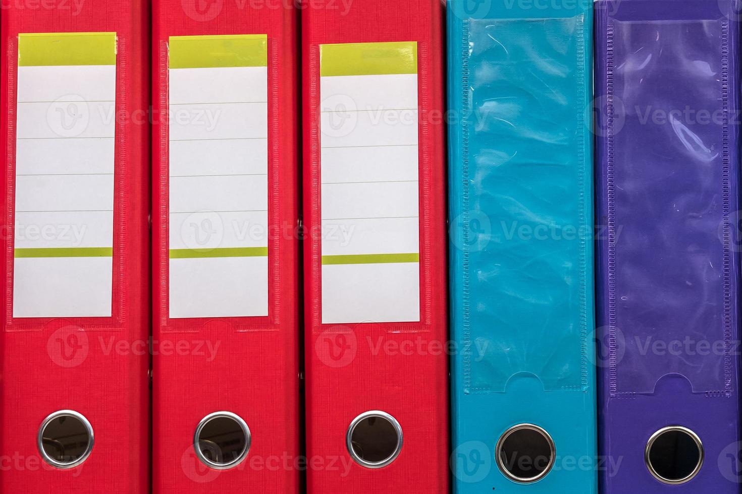 row of folders for papers and documentation on a shelf in the office photo