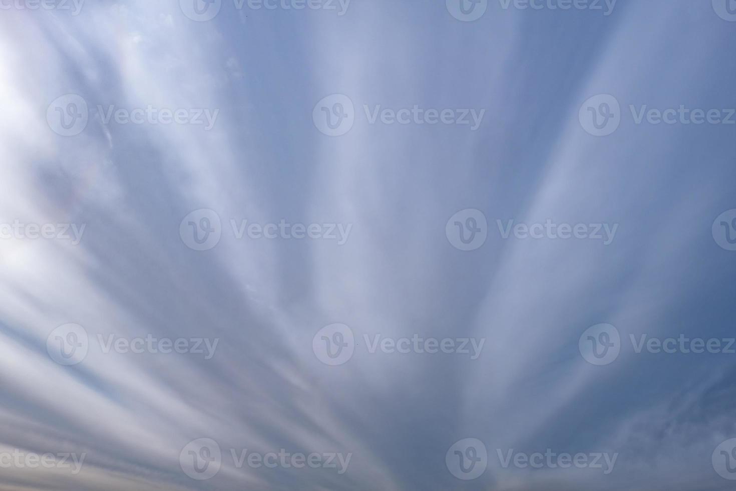 Blue sky background with tiny stratus cirrus striped clouds. Clearing day and Good windy weather photo