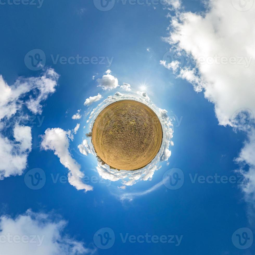 Little planet transformation of spherical panorama 360 degrees. Spherical abstract aerial view in field with awesome beautiful clouds. Curvature of space. photo