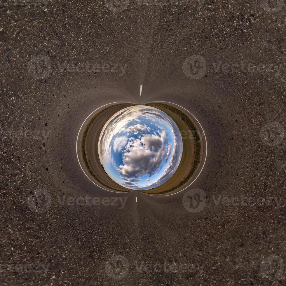 Little planet transformation of spherical panorama 360 degrees. Spherical abstract aerial view in field with awesome beautiful clouds. Curvature of space. photo