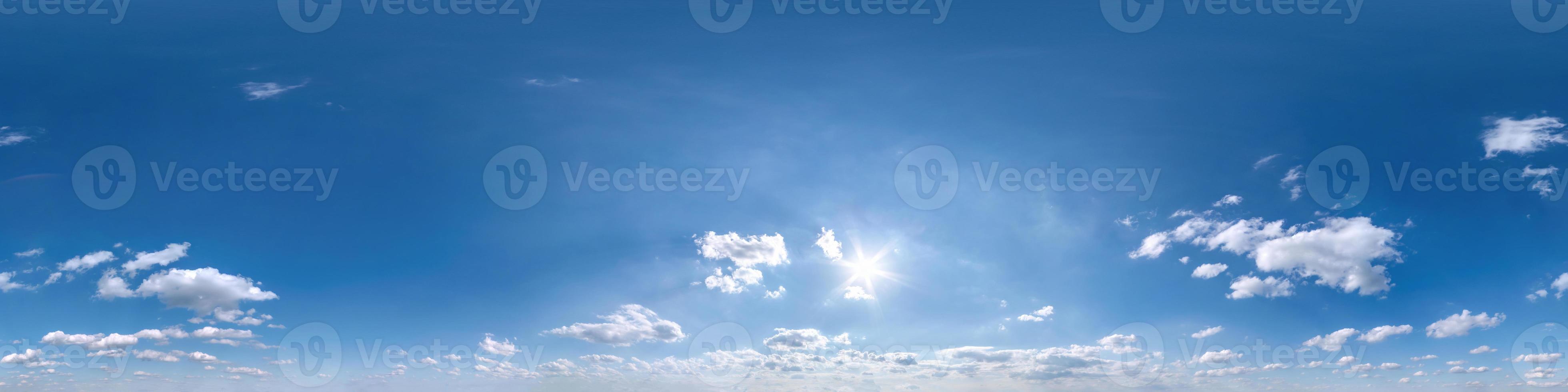 blue sky with beautiful fluffy cumulus clouds. Seamless hdri panorama 360 degrees angle view without ground for use in 3d graphics or game development as sky dome or edit drone shot photo