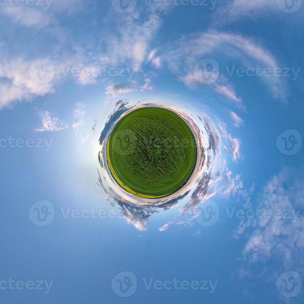 Little planet transformation of spherical panorama 360 degrees. Spherical abstract aerial view in field with awesome beautiful clouds. Curvature of space. photo