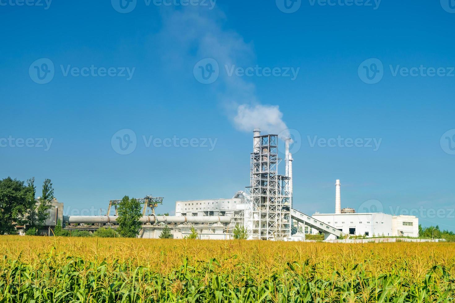 Industrial landscape environmental pollution waste of cement factory. Big pipes of industry enterprise plant. lime and chalk coated factory pipes photo