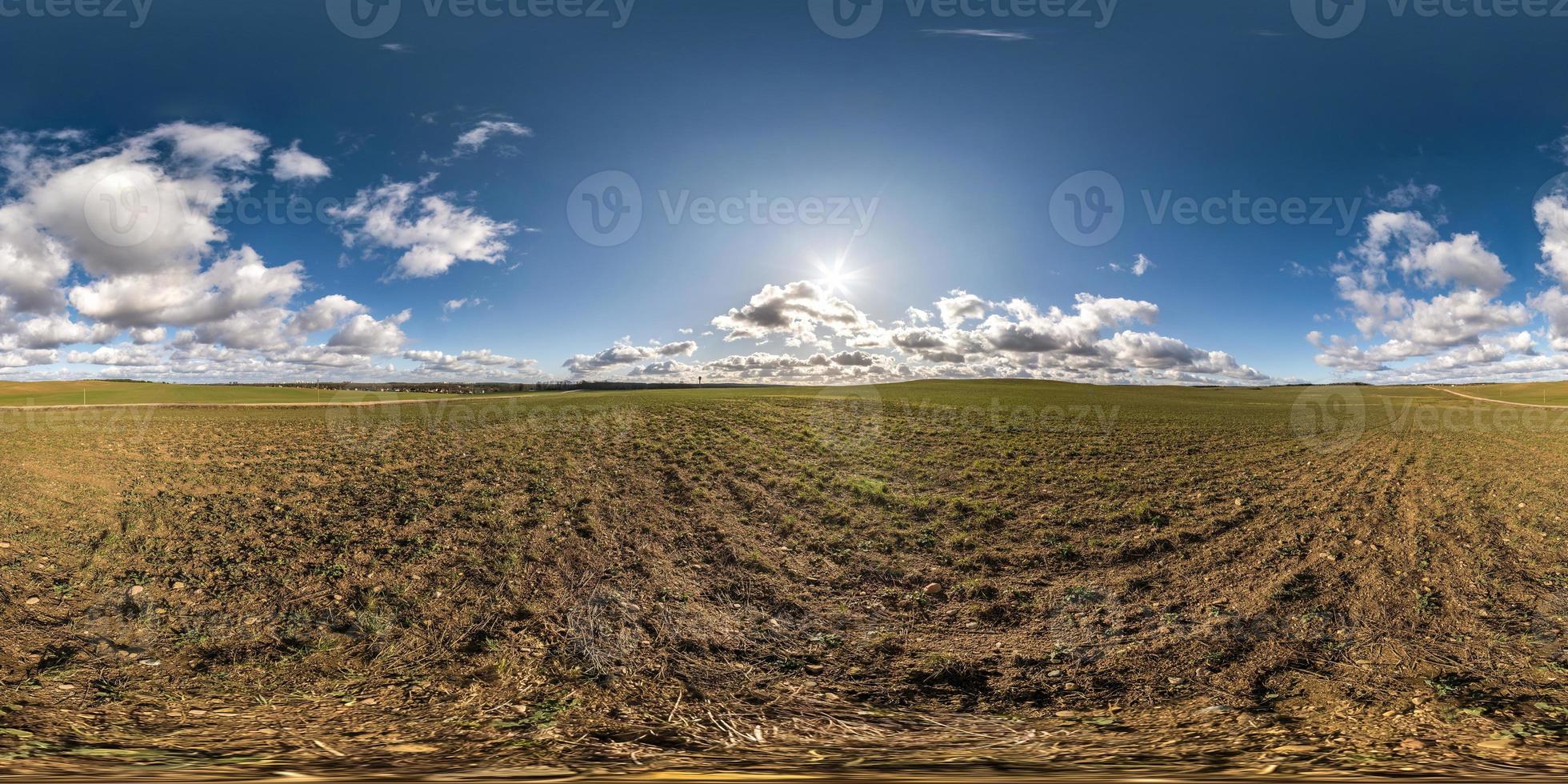 full seamless spherical hdri panorama 360 degrees angle view on gravel road among fields in spring day with awesome clouds in equirectangular projection, ready for VR AR virtual reality content photo