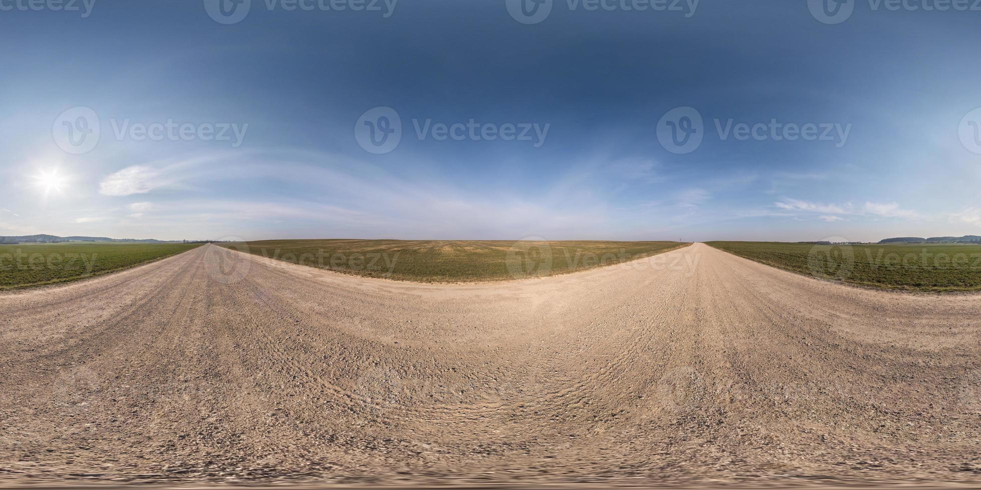 full seamless spherical hdri panorama 360 degrees angle view on gravel road among fields in spring day with clear sky in equirectangular projection, ready for VR AR virtual reality content photo