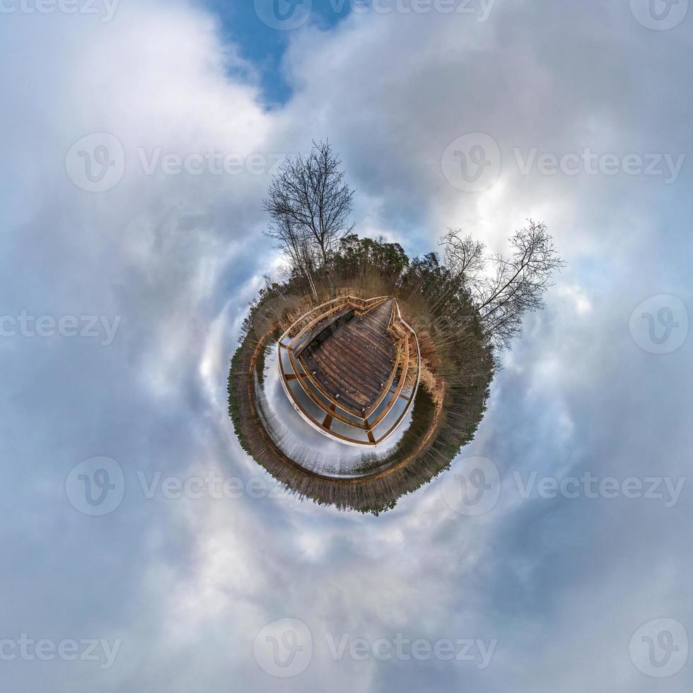 Little planet transformation of spherical panorama 360 degrees. Spherical abstract aerial view in field with awesome beautiful clouds. Curvature of space. photo