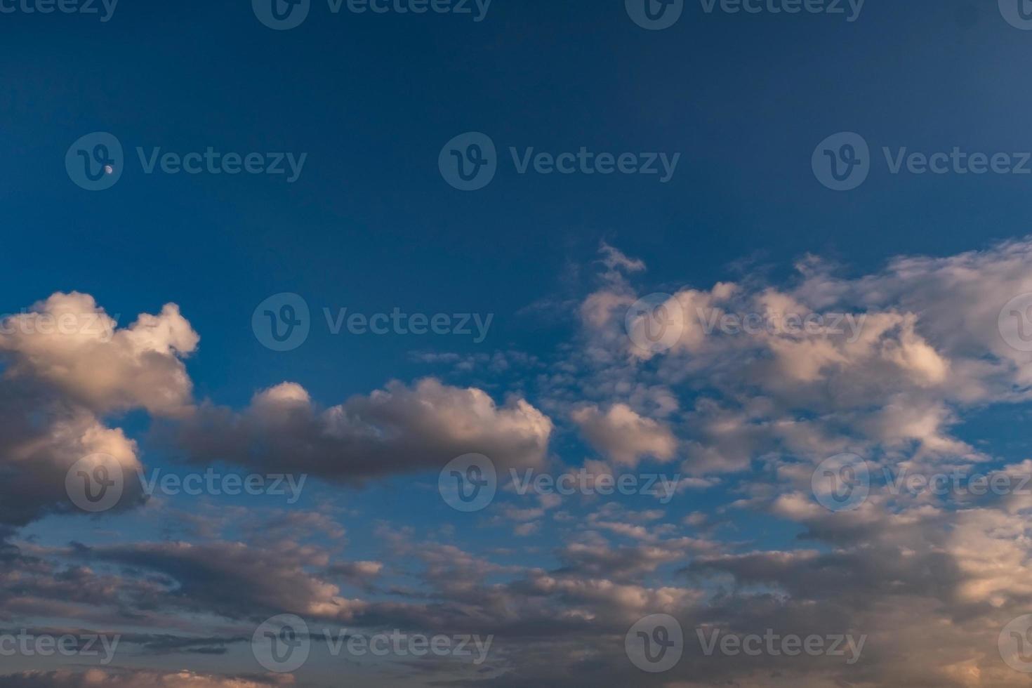 dark Blue sky background with tiny stratus cirrus striped clouds. Clearing evening and Good windy weather photo