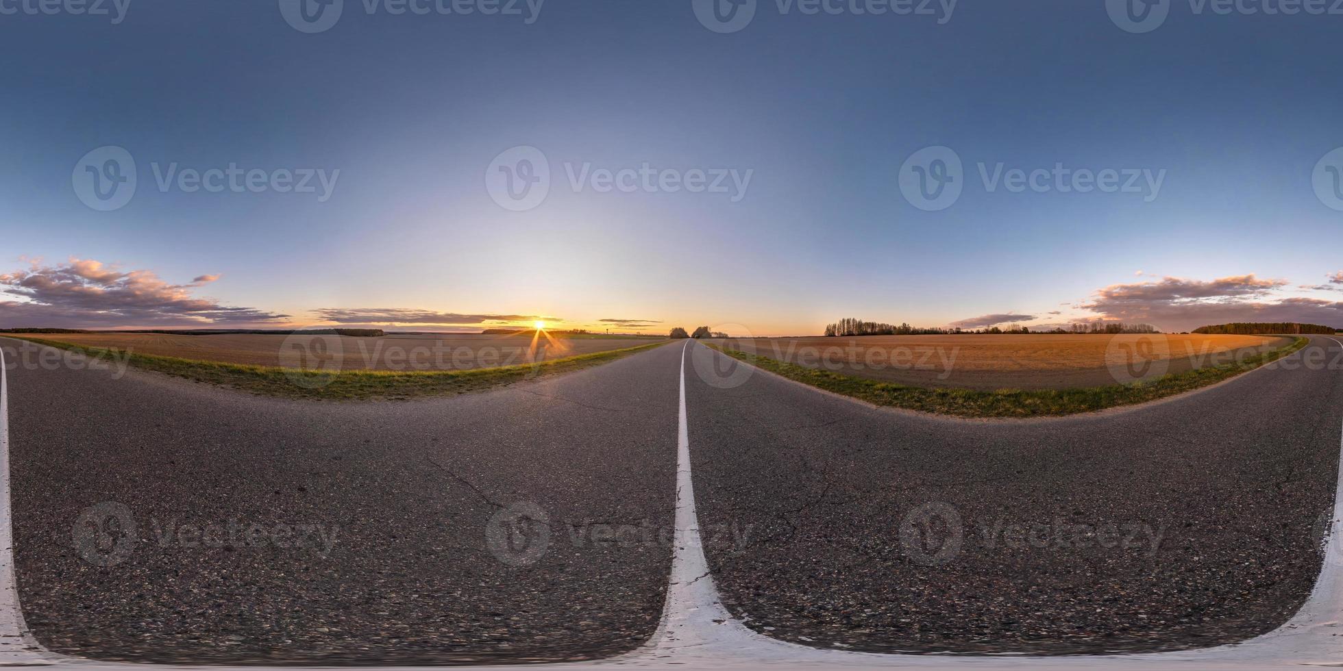 Full spherical seamless hdri panorama 360 degrees angle view on no traffic asphalt road among fields in evening  before sunset with clear sky. 360 panorama in equirectangular projection, VR AR content photo