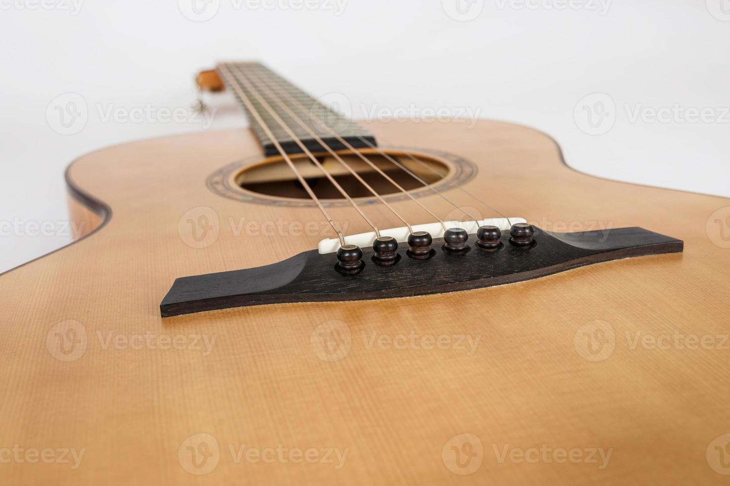 wood texture of lower deck of six strings acoustic guitar on white background. guitar shape photo