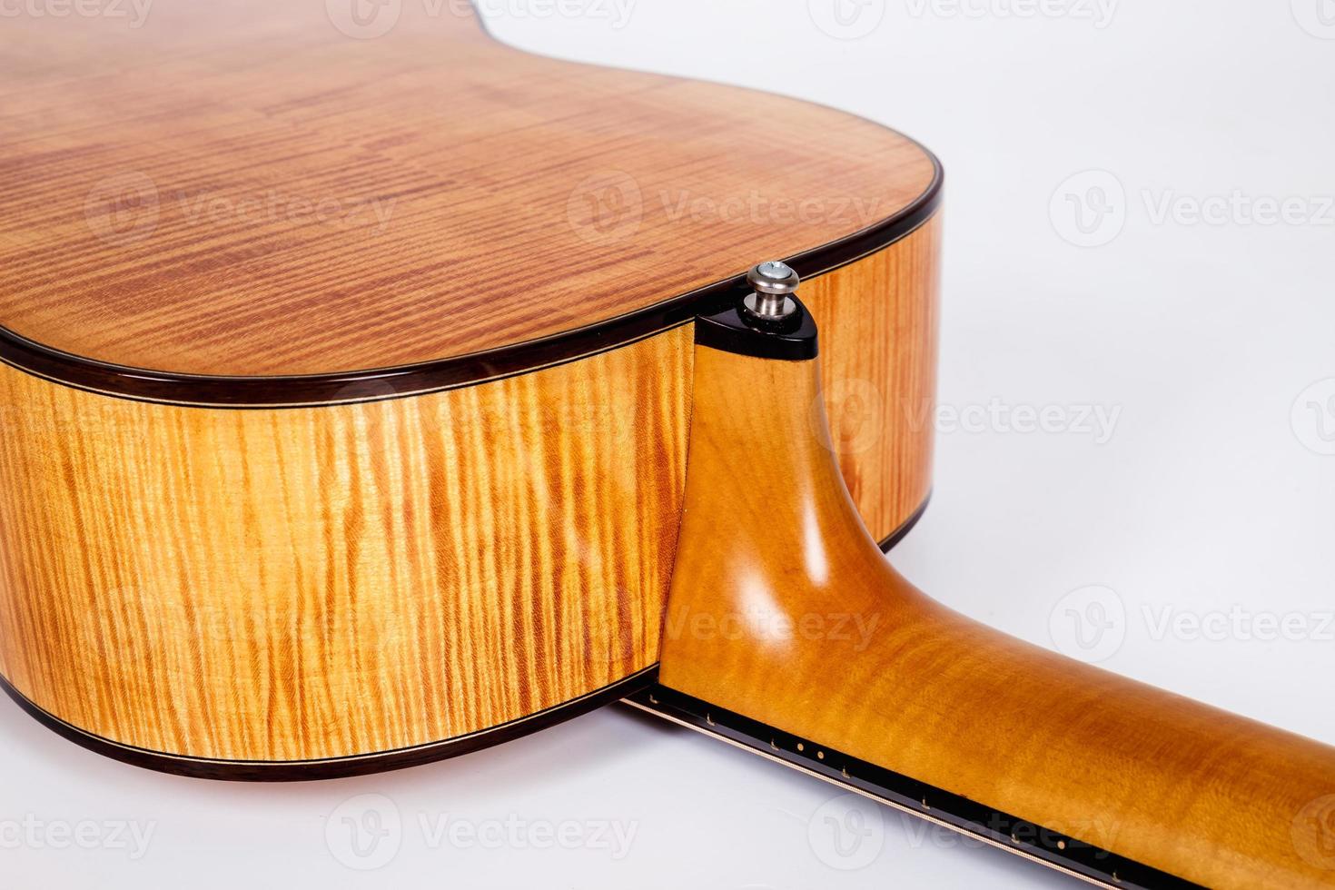 wood texture of lower deck of six strings acoustic guitar on white background. guitar shape photo