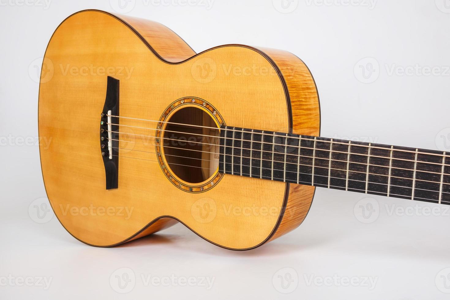 wood texture of lower deck of six strings acoustic guitar on white background. guitar shape photo