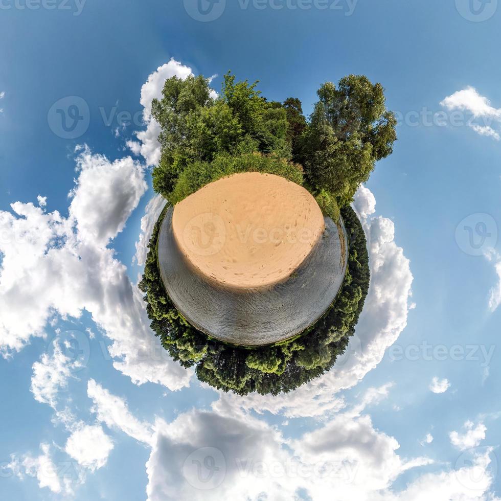 Little planet transformation of spherical panorama 360 degrees. Spherical abstract aerial view in field in nice evening with awesome beautiful clouds. Curvature of space. photo