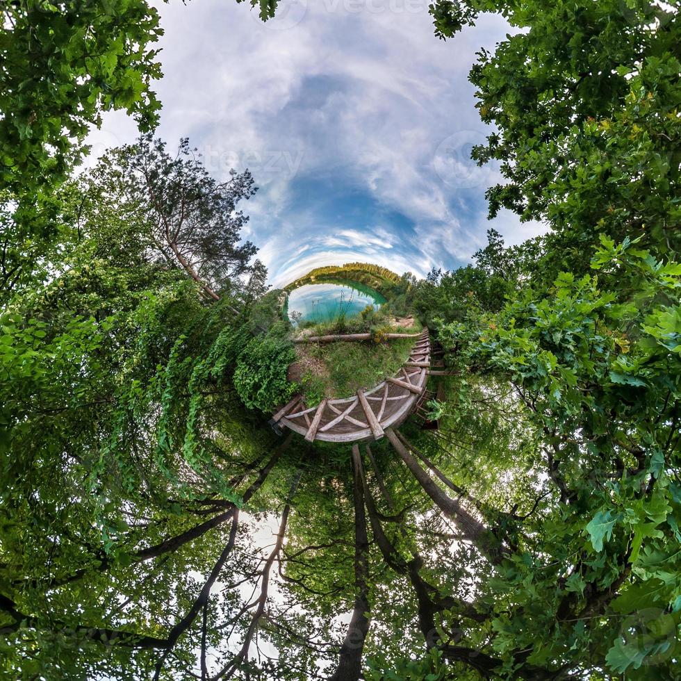 Little planet transformation of spherical panorama 360 degrees. Spherical abstract aerial view in field with awesome beautiful clouds. Curvature of space. photo