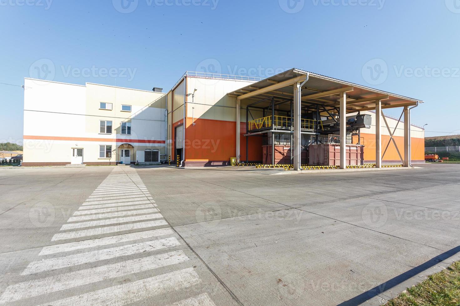 manufacture building of modern waste recycling processing plant in orange style. Separate garbage collection. Recycling and storage of waste for further disposal. photo