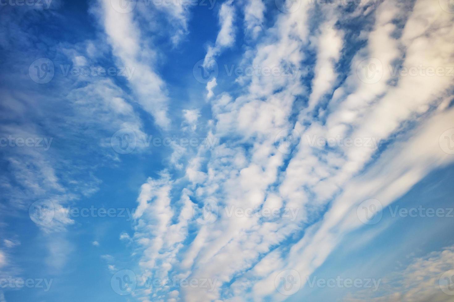 Blue sky background with tiny stratus cirrus striped clouds. Clearing day and Good windy weather photo