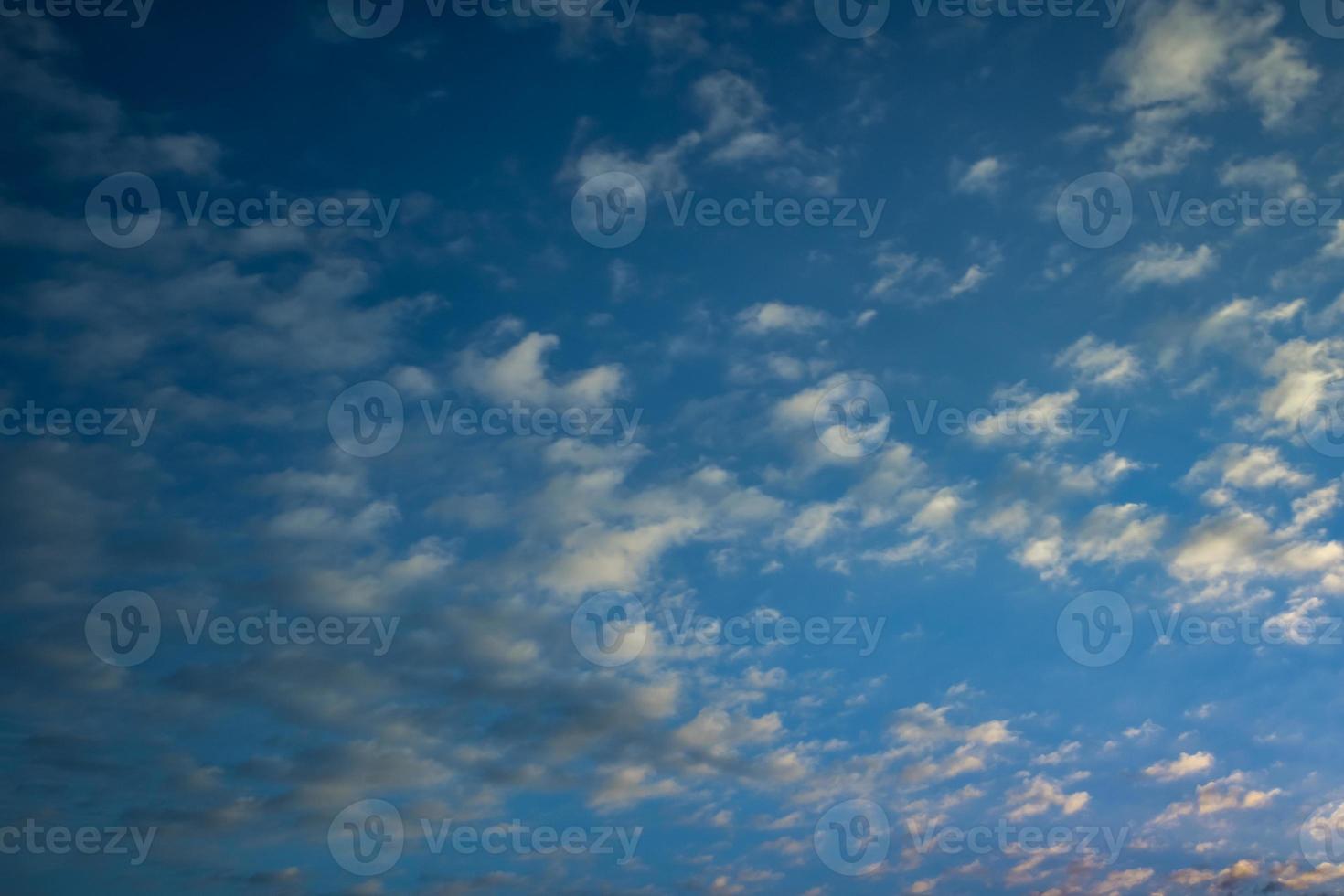 dark Blue sky background with tiny stratus cirrus striped clouds. Clearing evening and Good windy weather photo