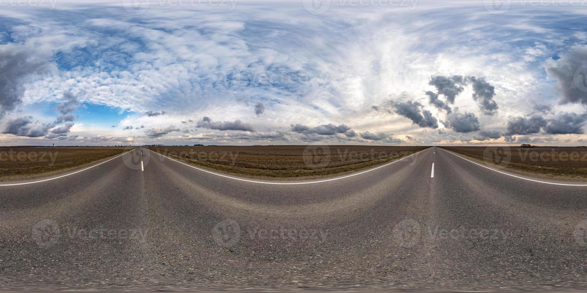 full seamless spherical hdri panorama 360 degrees angle view on asphalt road among fields in early spring day with sun on cloudy sky in equirectangular projection, ready for VR AR content photo