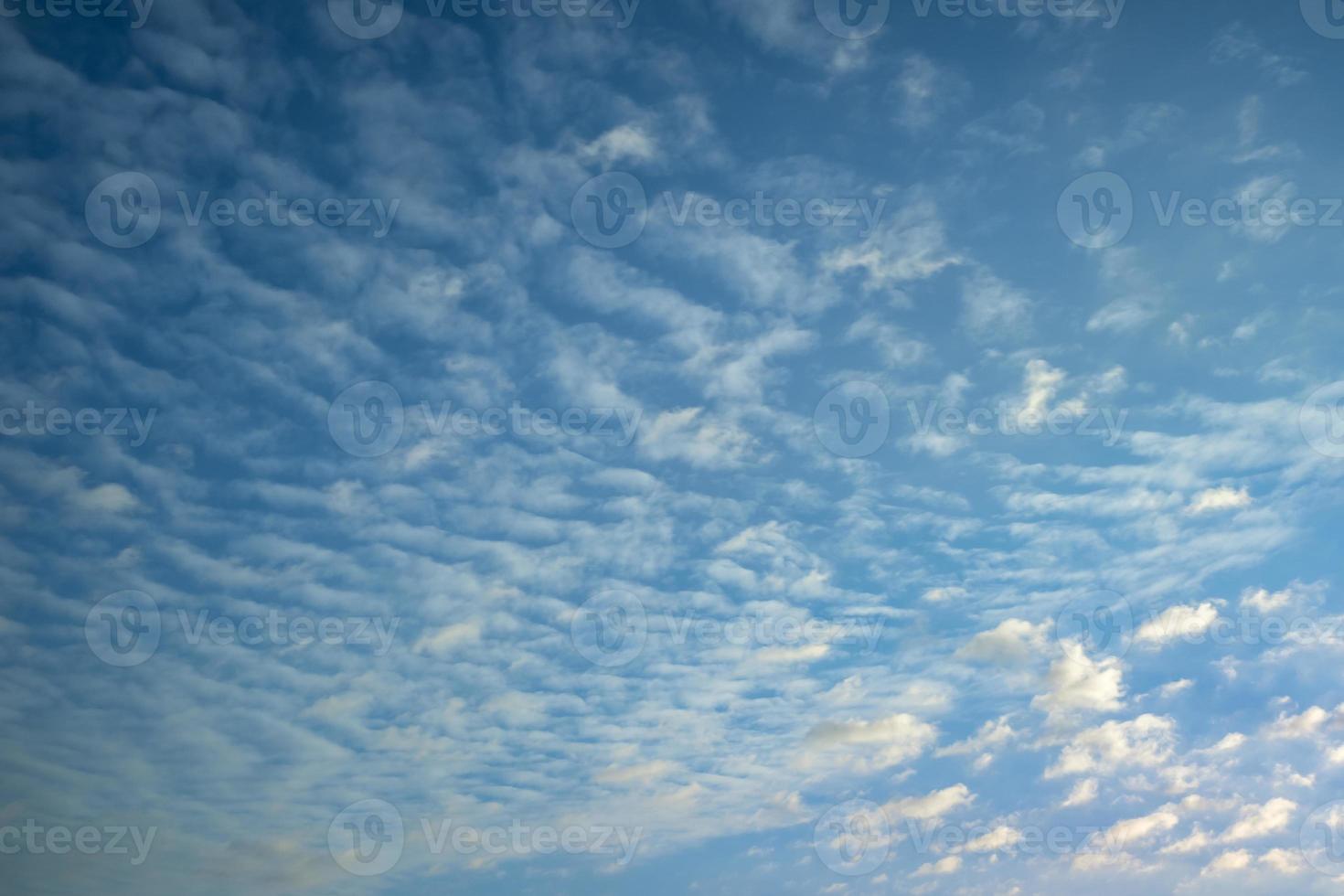 dark Blue sky background with tiny stratus cirrus striped clouds. Clearing evening and Good windy weather photo