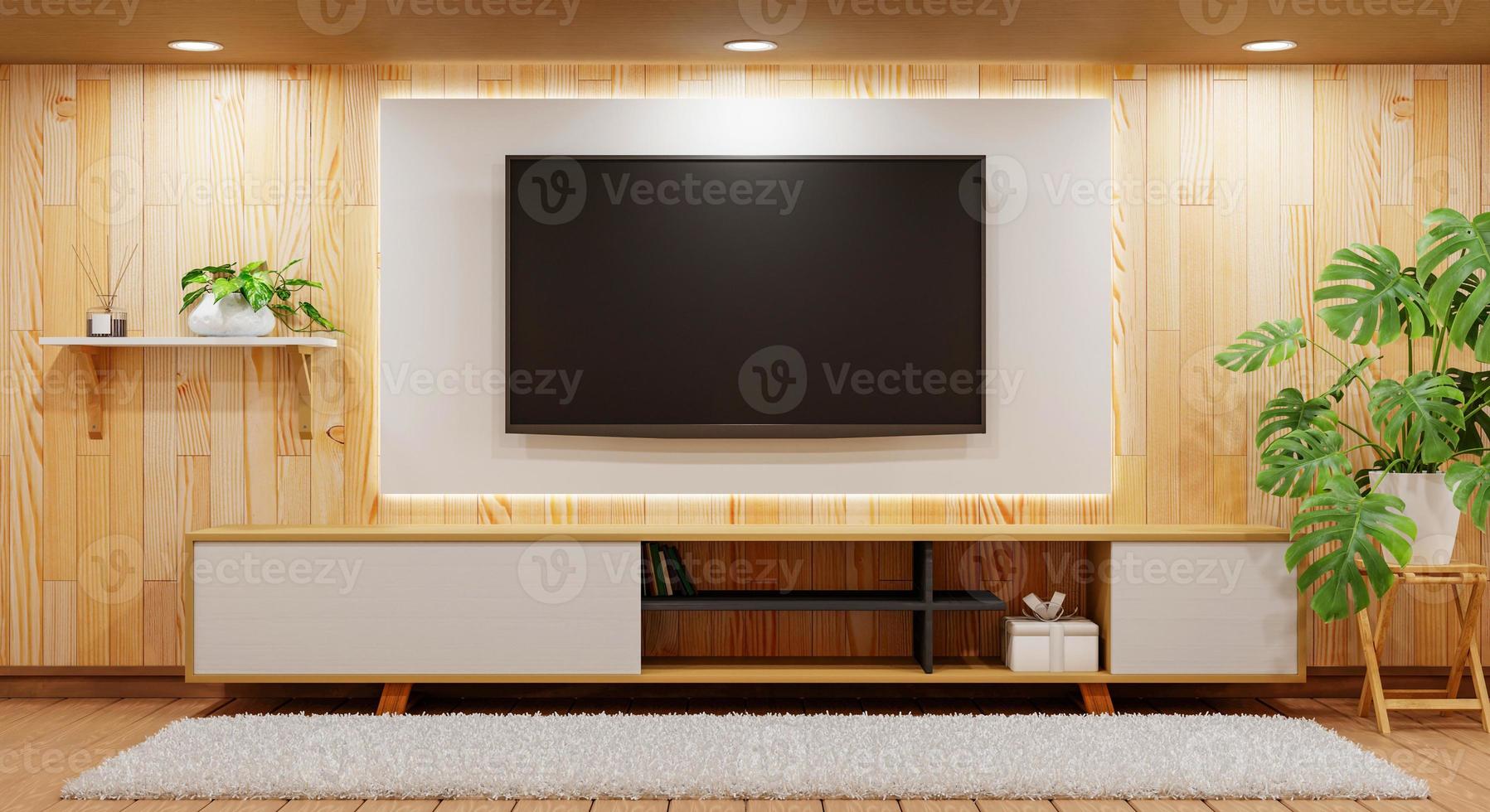 tv encima del armario de madera en una habitación vacía moderna con moqueta de plantas y lámpara de luz sobre fondo de madera. tema de estilo japonés. arquitectura y concepto interior. representación de ilustración 3d foto