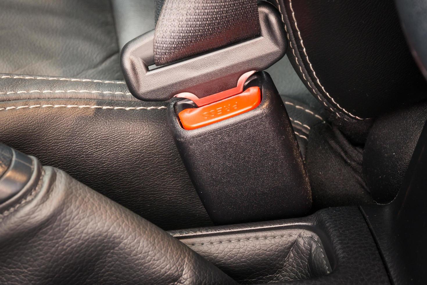 Close-up of the buckle of a seat belt or safety belt for driving and transportation by car. photo