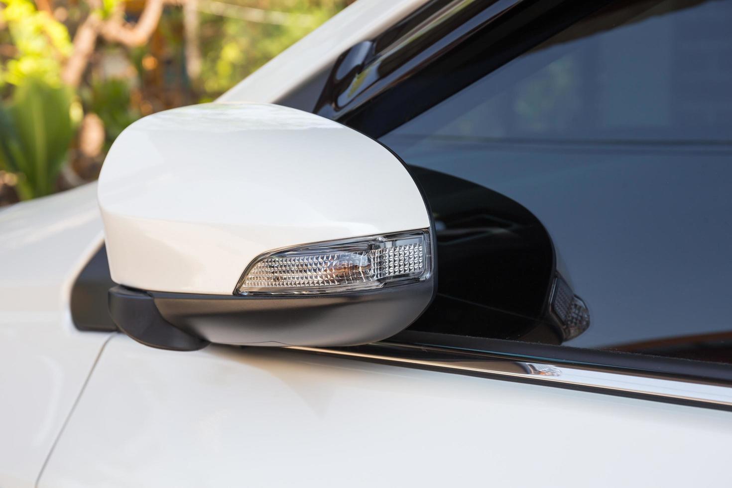 modern white car side view mirror folded with turn signal photo