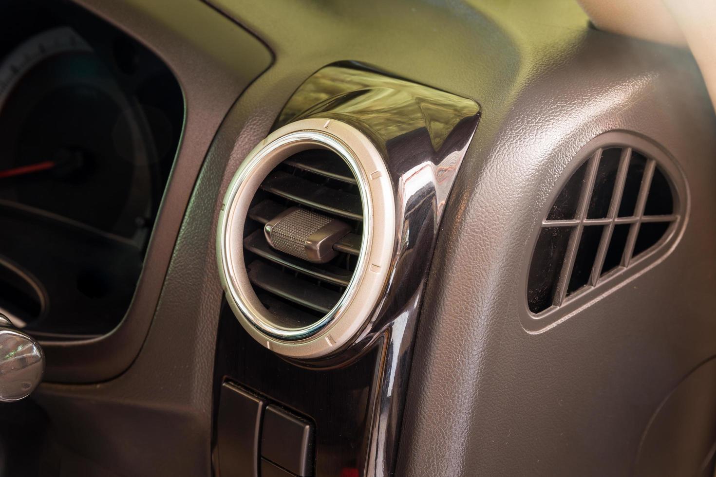 Modern car air conditioning system grid panel on console photo
