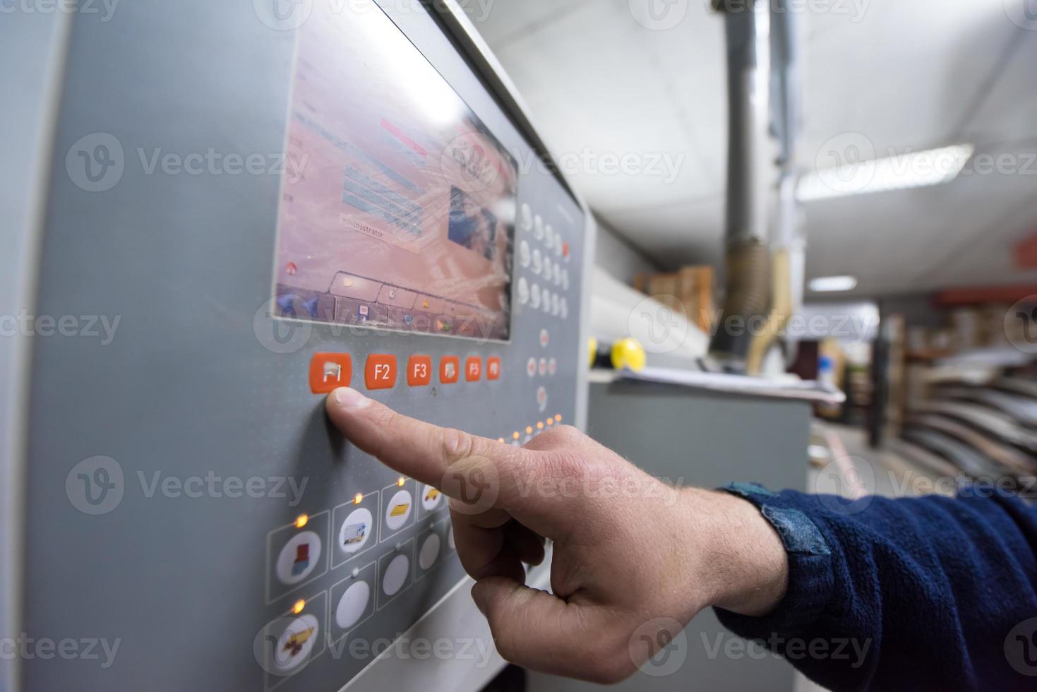 carpenter calculating and programming a cnc wood working machine photo