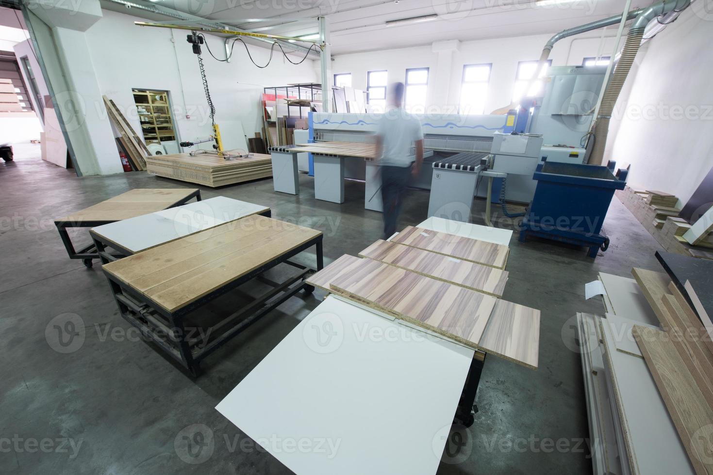 worker in a factory of wooden furniture photo