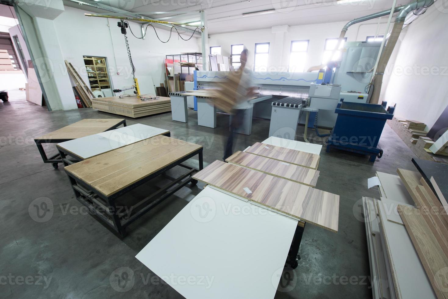 worker in a factory of wooden furniture photo