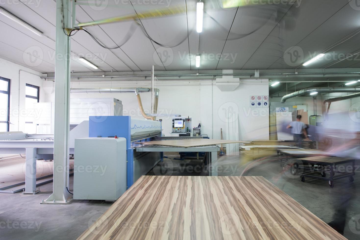 worker in a factory of wooden furniture photo