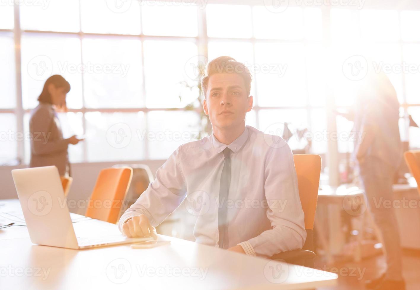 Young businessman using computer at work photo