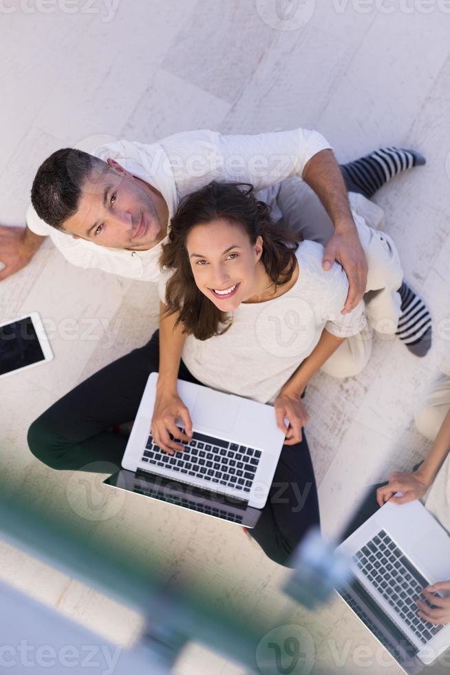 couple using tablet and laptop computers top view photo