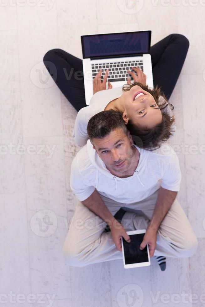 couple using tablet and laptop computers top view photo