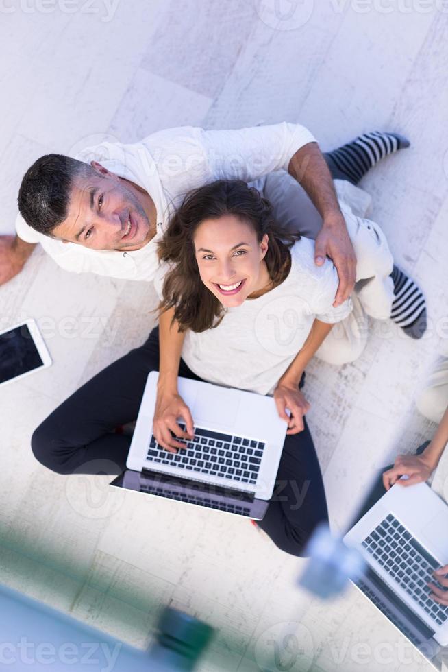 couple using tablet and laptop computers top view photo