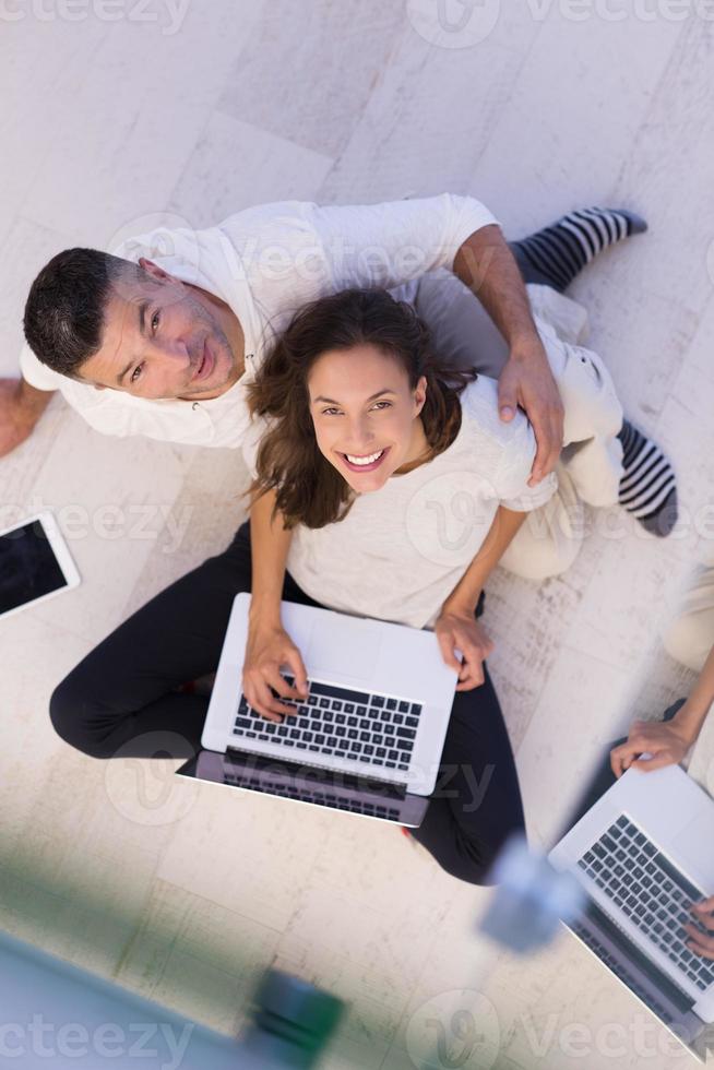 couple using tablet and laptop computers top view photo