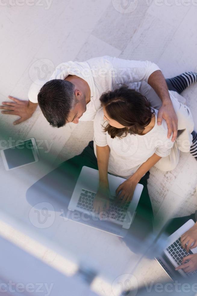 couple using tablet and laptop computers top view photo