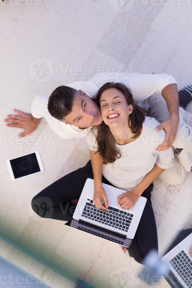 couple using tablet and laptop computers top view photo