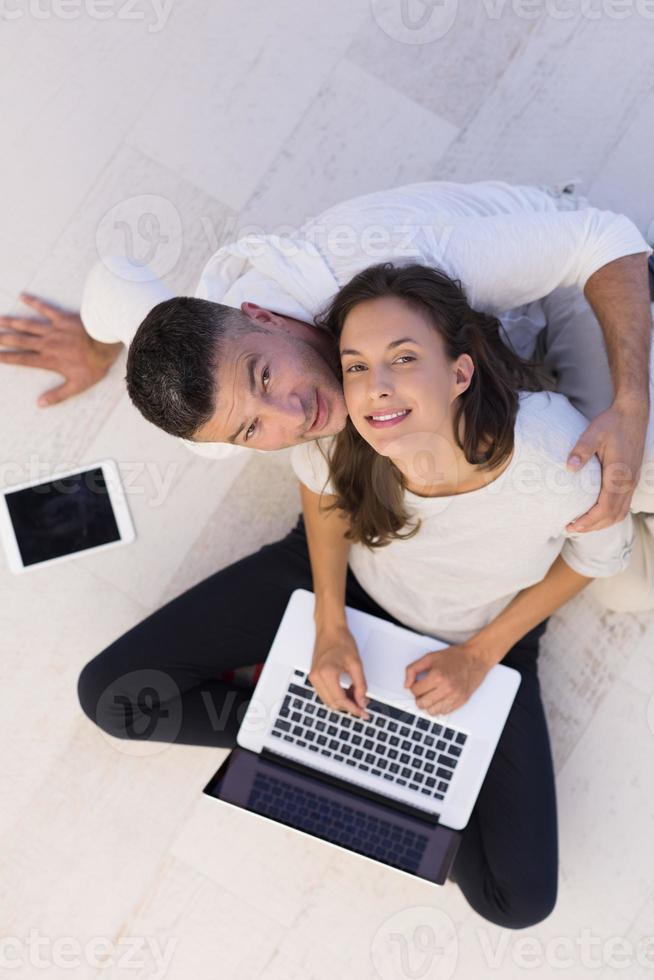couple using tablet and laptop computers top view photo