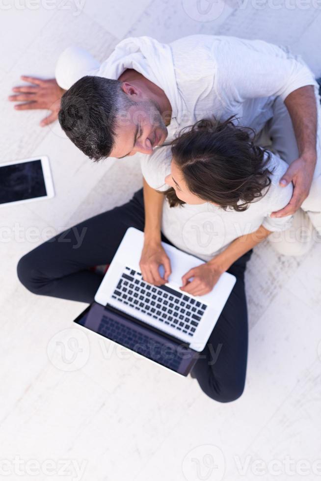 couple using tablet and laptop computers top view photo