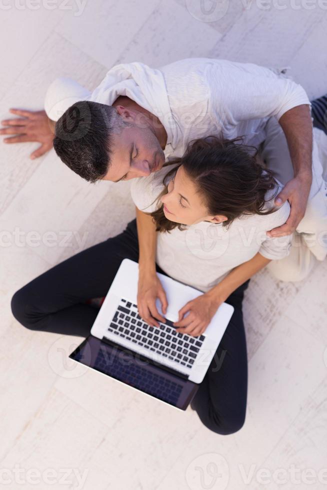 couple using tablet and laptop computers top view photo